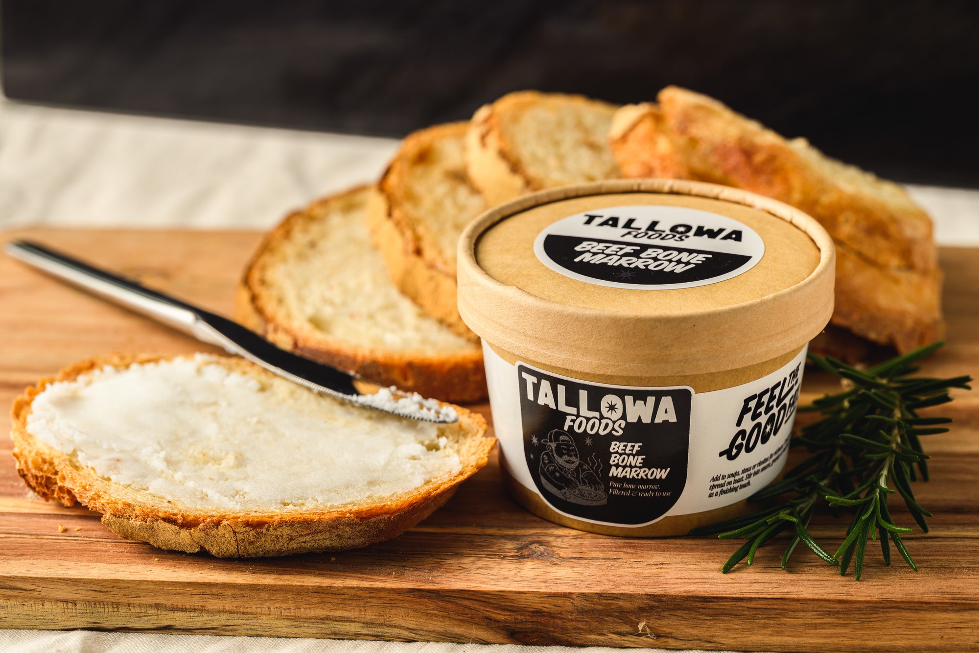 Tallowa beef bone marrow spread on Maltese bread with knife ancestral nutrient rich food