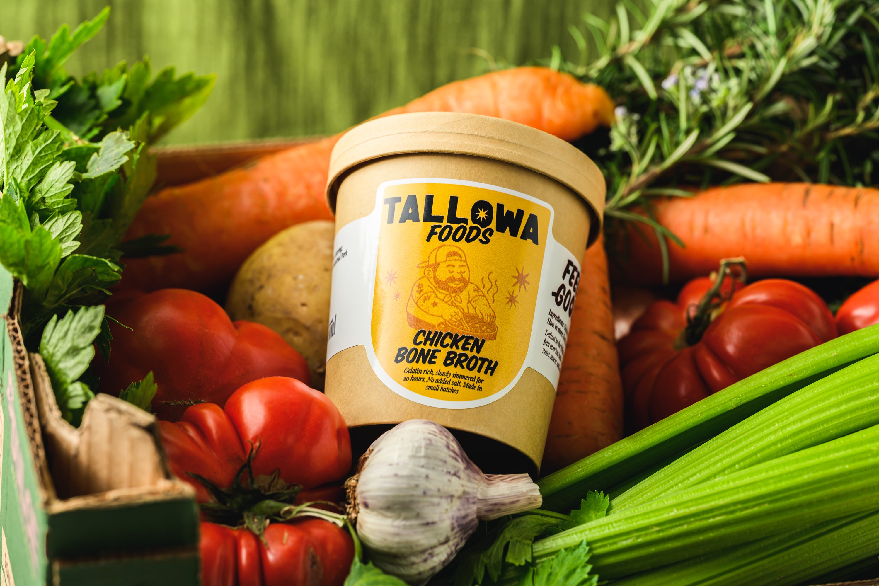 Tallowa chicken bone broth jar surrounded by fresh vegetables natural slow simmered broth