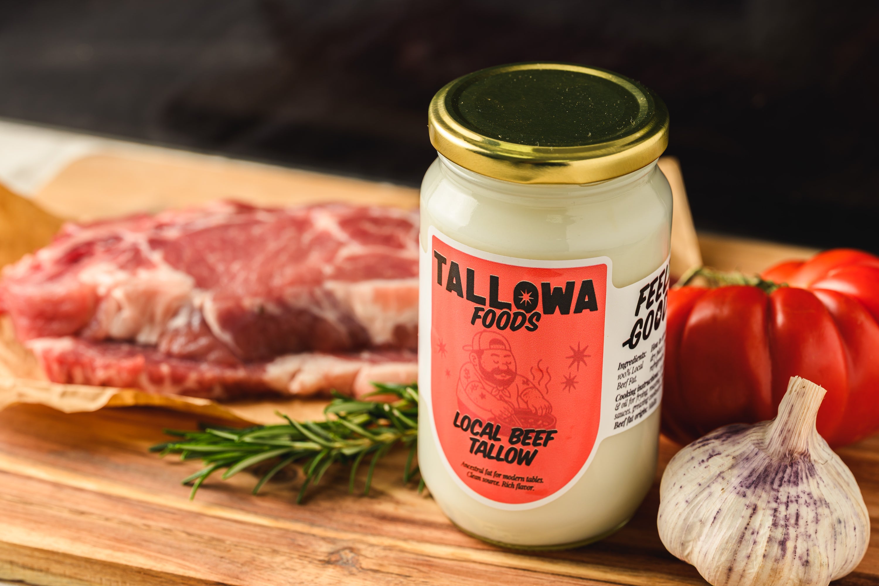Tallowa local beef tallow cooking fat with steak garlic herbs and tomatoes on wooden board in Malta Europe